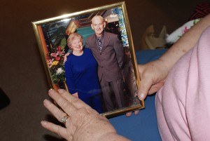 Joan Johnston holds a portrait of her and husband Ron in happier times.
