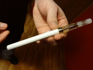 Craig Smith holds a refillable electronic cigarette