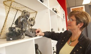 Janet Evans examines a sculpture of a hockey goaltender.