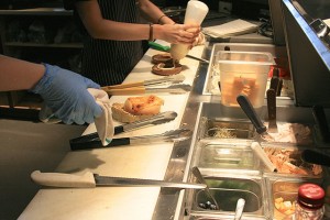 Staff prepare bagels.