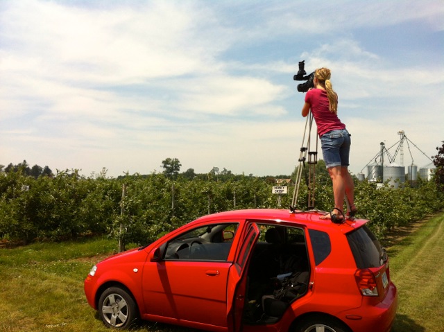 Student standing on roof of car