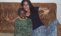 Western med student helps Tanzanian kids Supriya poses with a Tanzania child.