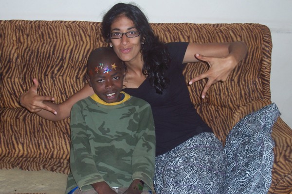 Supriya poses with a Tanzania child.