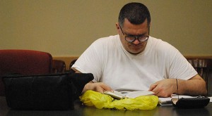 Grit Uplifted writer Dan Lenart reads from a tattered copy of A Handbook to Literature during a recent meeting