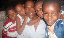 Jamaicans literally running in someone else’s shoes D’Lenney Grant, centre, travels to Jamaica every two months to visit and provide for his 250 sponsored children. <br />
Photo courtesy of D’Lenney Grant.<br />