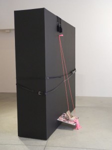 The big black box, girdled by belts and decorated with everyday objects  Photo by Patricia Barrett