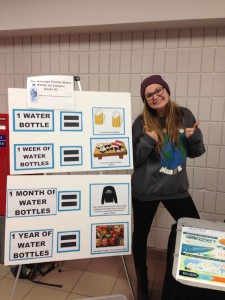 Mackenzie Coombe of Envirowestern, enthusiastically poses with the Western Water Week display. (Photo: Emily McWilliams)