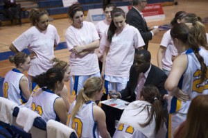 Angela Tilk (second from the left, standing) listens to Charles Kissi talk to his team during a time-out at Ryerson University.