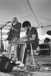 Olenka Krakus and Simon Larochette play an outdoor festival gig together. 