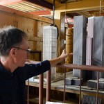 Dr. Craig Miller shows off models used to test the Twin Towers. Photo by Ross Howey.