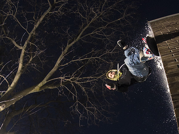 One of London's urban snowboarders rides down a wall.